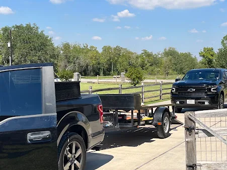 J. Tullos Services truck towing an equipment trailer to an air conditioning job